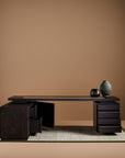 Modern black desk with decorative items on a brown background