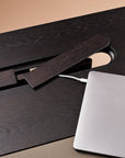 Laptop on a wooden desk with a beige background