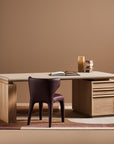 Modern desk with a chair against a brown wall