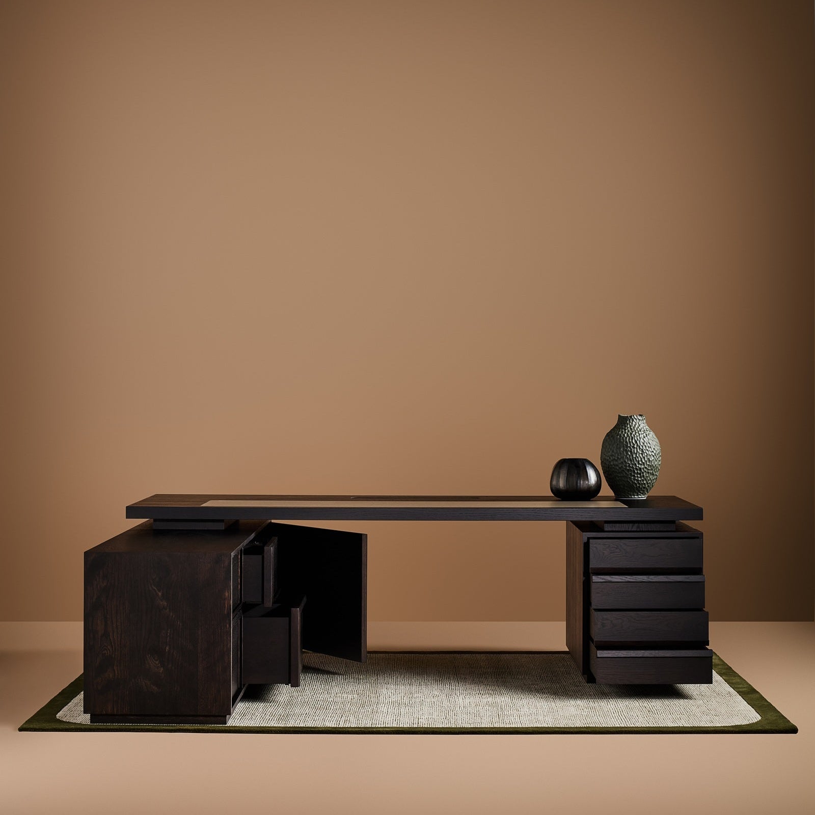 Modern black desk with decorative items on a brown background