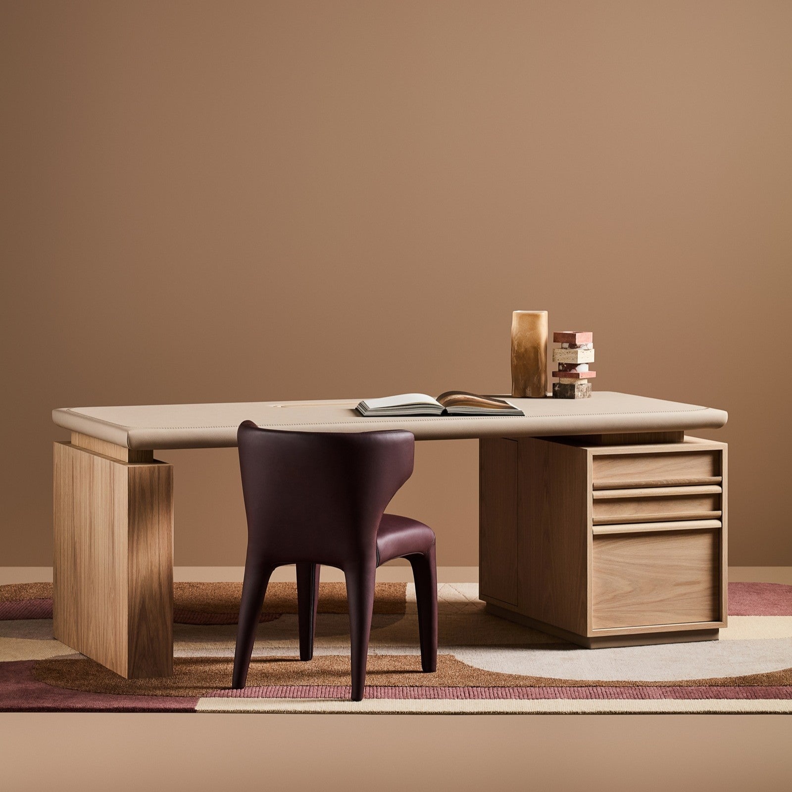 Modern desk with a chair against a brown wall