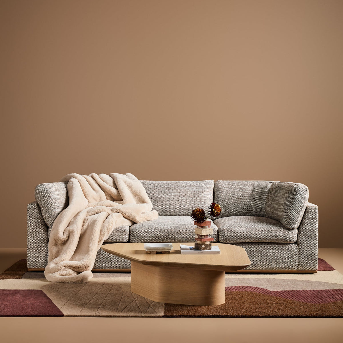 Sabrina Curved Sofa on leather plinth in Matrix Woven Dream with Tan Leather plinth